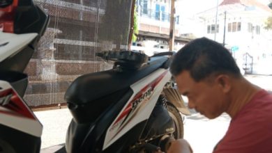 Maun saat melakukan reparasi motor pelanggannya.